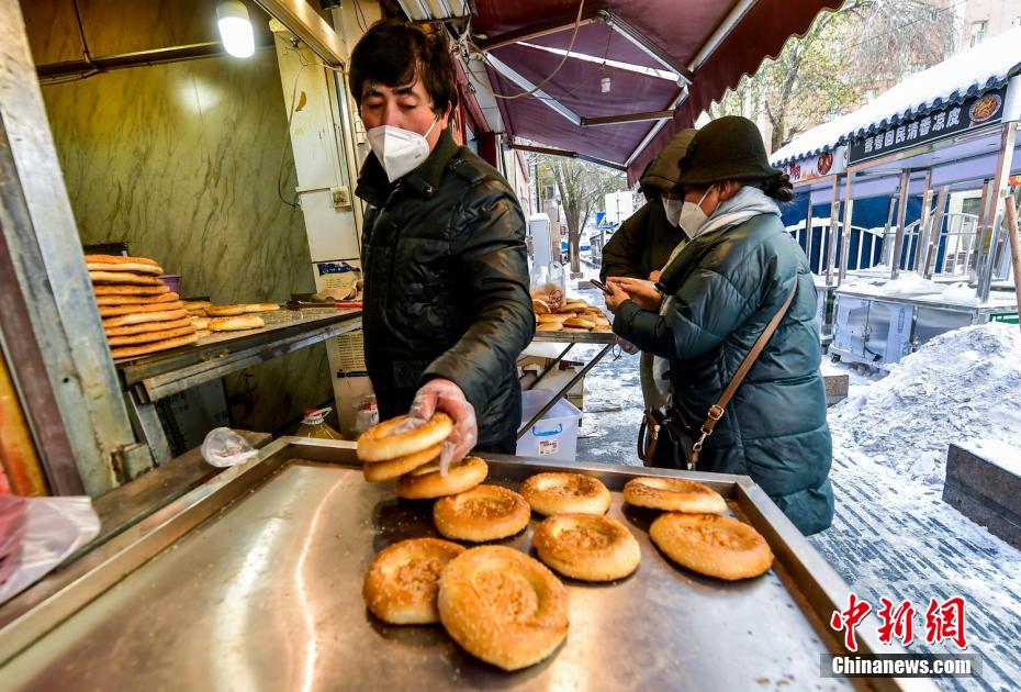 烏魯木齊市文化路，已開門營業(yè)的馕店吸引過往市民前來購買。 劉新 攝